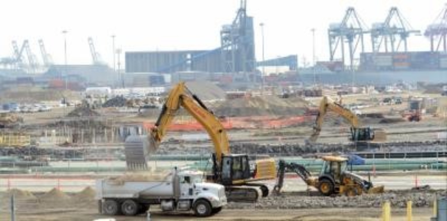 Construction equipment working at a port or industrial site.