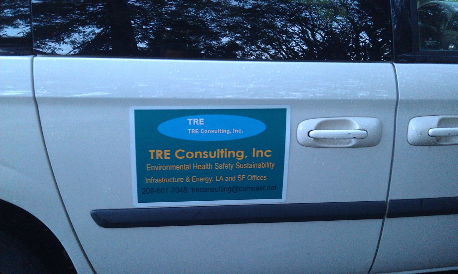 TRE Consulting vehicle with company door signage.